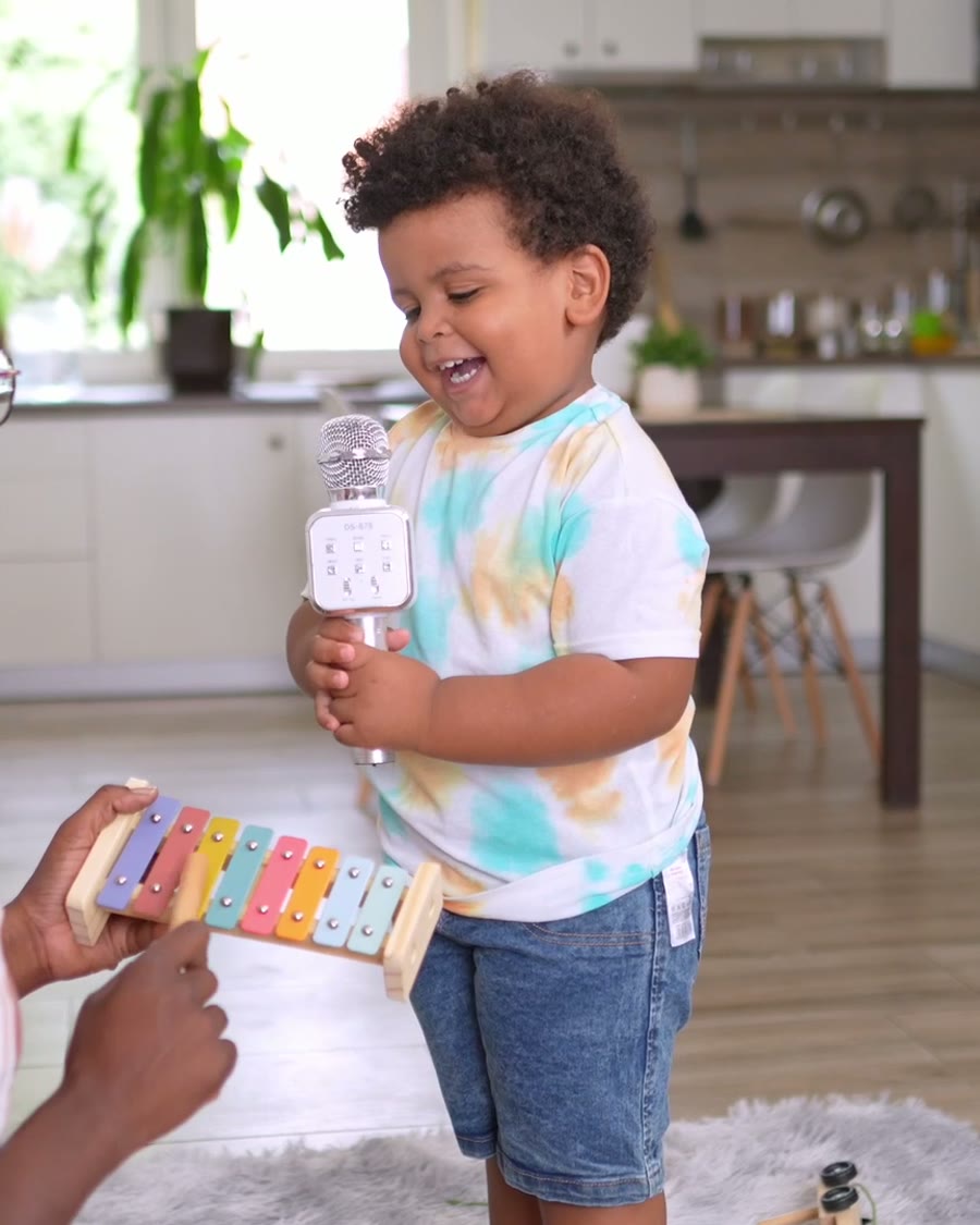 Sammy singing into his karaoke microphone at home